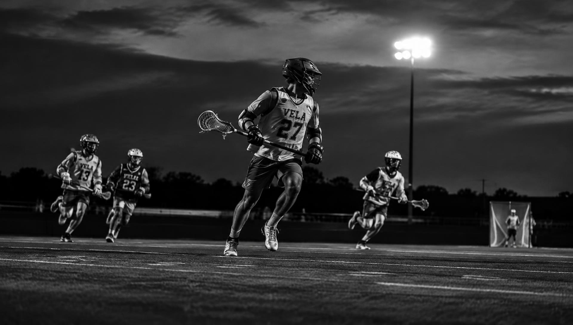 Lacrosse players competing under stadium lights